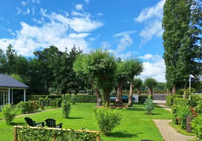 a park with chairs and trees on a lawn at Park De Driesprong in Nieuwveen