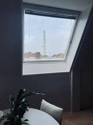 a window in a room with a table and a plant at Have a nice stay! - Main Street beachapartment, beach 150 meters in Noordwijk aan Zee