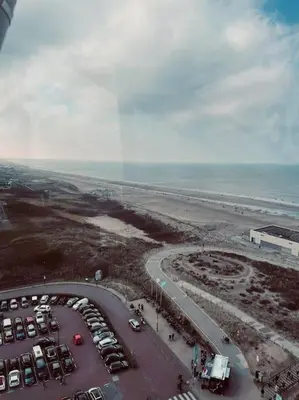 an aerial view of a parking lot next to the ocean at Have a nice stay! - Main Street beachapartment, beach 150 meters in Noordwijk aan Zee