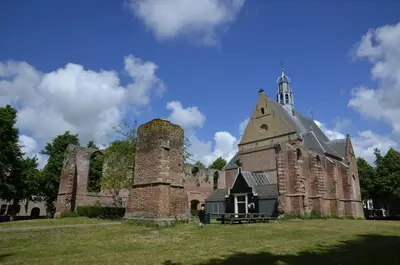 an old building with a tower and a church at Duin Cottage Bergen in Bergen