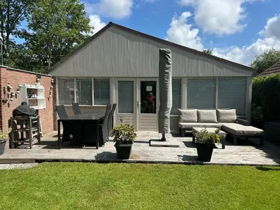 a patio with a couch and a table at Rekerlanden 104 in Schoorldam