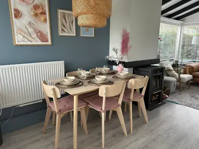 a dining room with a table with chairs and a dining room at Rekerlanden 104 in Schoorldam