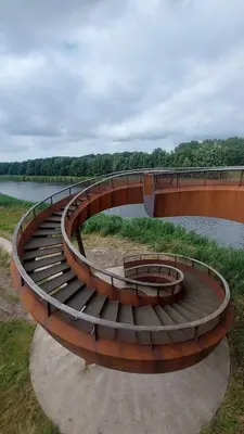 a bridge over a body of water next to a river at Ecolodge Almere in Almere
