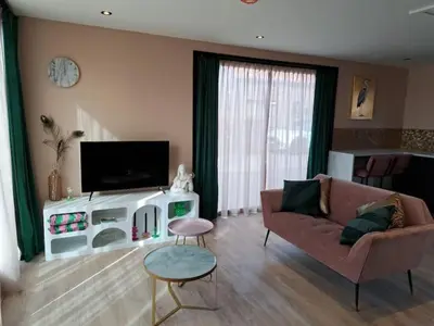 a living room with a couch and a tv at Hooischuur Wakker in Eemnes
