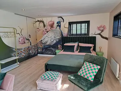 a bedroom with a large peacock painting on the wall at Hooischuur Wakker in Eemnes