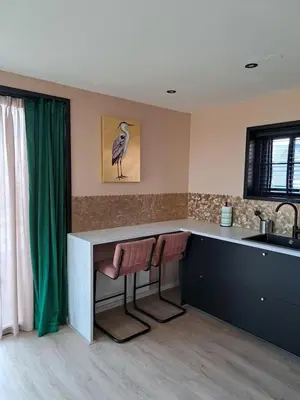 a kitchen with a counter with a bird on the wall at Hooischuur Wakker in Eemnes