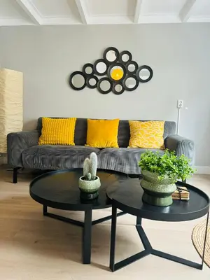 a living room with a couch and a table at Hello Katwijk - Zomerhuis Paul Krügerstraat 3 in Katwijk aan Zee