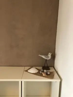 a table with a bird and shells on it at Vakantiehuis in Katwijk aan zee in Katwijk aan Zee