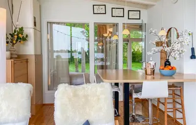 a kitchen with a table and chairs in a room at Lakehouse Reeuwijk in Reeuwijk