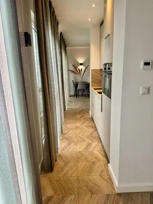 a hallway with a kitchen and a dining room at Homes by the C in Zandvoort