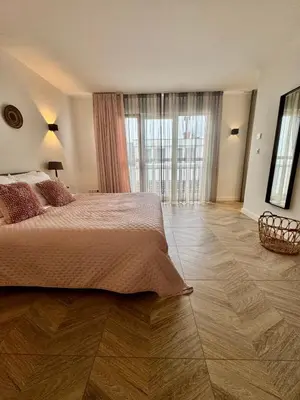 a bedroom with a bed and a large window at Homes by the C in Zandvoort