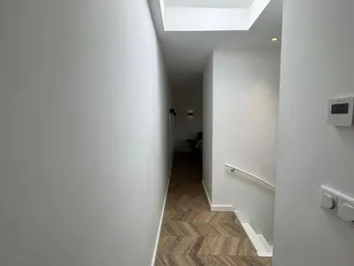 a hallway with a skylight in a white room at Homes by the C in Zandvoort