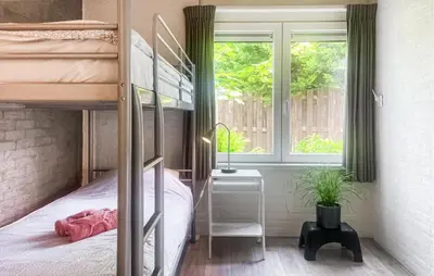 a bedroom with a bunk bed and a window at 2 Bedroom Cozy Home In Noordwijkerhout in Noordwijkerhout