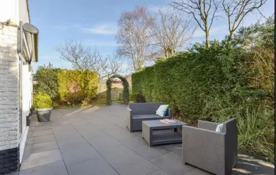 a patio with two chairs and a table at 2 Bedroom Nice Home In Noordwijkerhout in Noordwijkerhout