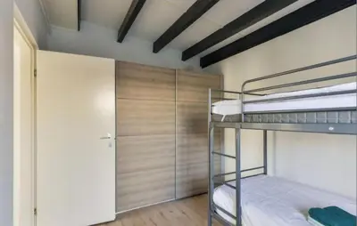 a room with two bunk beds and a closet at 2 Bedroom Nice Home In Noordwijkerhout in Noordwijkerhout