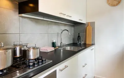 a kitchen with pots and pans on a stove at 2 Bedroom Nice Home In Noordwijkerhout in Noordwijkerhout