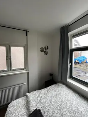 a bedroom with a bed and a window at Apartement hotel Stays by ADM in Leiden