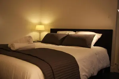 a bedroom with a large bed with white sheets and pillows at B&B Keizers Canal in Amsterdam