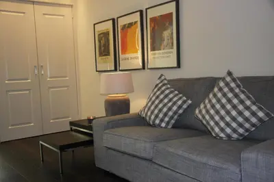 a living room with a couch and a table with pillows at B&B Keizers Canal in Amsterdam