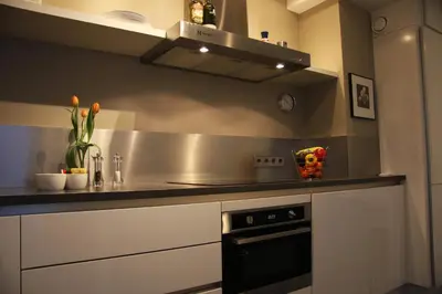 a kitchen with a sink and a stove at B&B Keizers Canal in Amsterdam