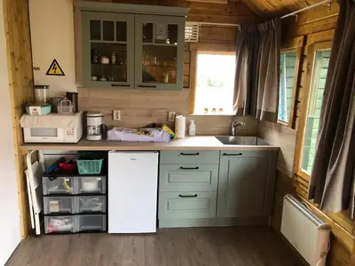 a small kitchen with a sink and a counter at Have a nice stay! - Vakantiehuis 't Klavertje in Noordwijk