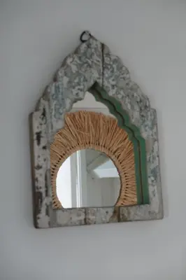 a mirror with a wooden frame on a wall at Ithaka Beach House, unieke plek met vrij parkeren! in Noordwijk