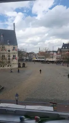a city square with a building and a bus at Apartement City Center Gouda: View Deluxe in Gouda