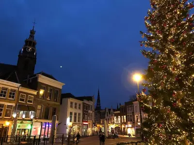 a christmas tree in a town with a clock tower at Apartement City Center Gouda: View Deluxe in Gouda