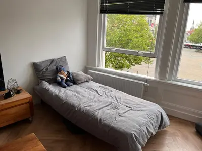 a bedroom with a bed with a teddy bear on it at Apartement City Center Gouda: View Deluxe in Gouda