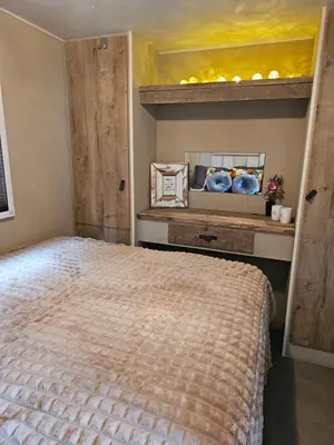 a bedroom with a large bed in a room at Slapen in Tuitje in Tuitjenhorn