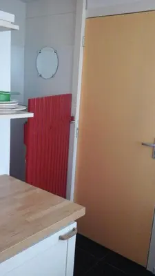 a kitchen with a red door in a room at Studio 99 in Amsterdam