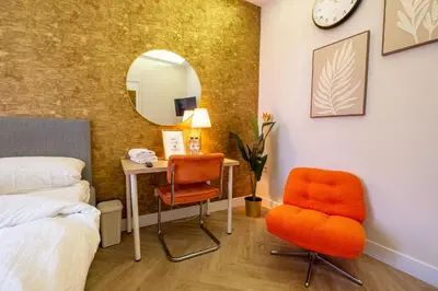 a bedroom with a bed and a desk and a chair at Hello Stay Utrecht in Utrecht