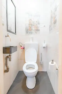 a bathroom with a toilet and a sink at Hello Stay Utrecht in Utrecht