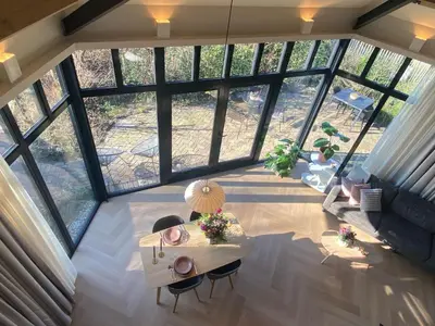 an overhead view of a living room with a table at Ons Huisje Achter - De Hooischuur in Noordwijkerhout
