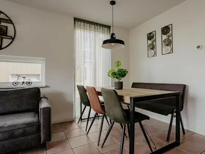 a dining room with a table and chairs at Busch en Dam in Uitgeest