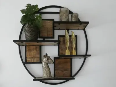 a round wooden shelf with a giraffe on a wall at Busch en Dam in Uitgeest