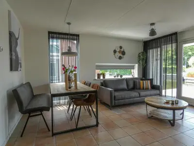 a living room with a couch and a table at Busch en Dam in Uitgeest