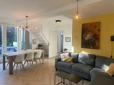 a living room with a couch and a table at Ons Huisje Achter in Noordwijkerhout