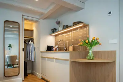 a kitchen with a vase of flowers on a counter at Storehouse Studios in Amsterdam