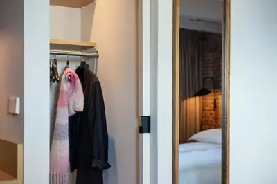 a closet with a mirror next to a bedroom at Storehouse Studios in Amsterdam