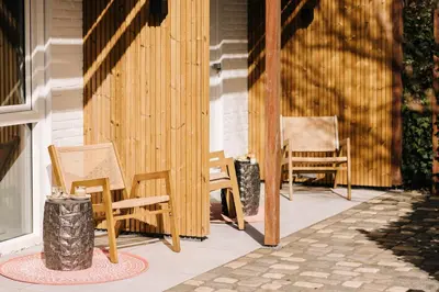 a porch with two chairs at Hotel Keur - Apartments in Zandvoort
