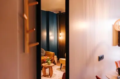 a door leading to a living room with a table at Hotel Keur - Apartments in Zandvoort