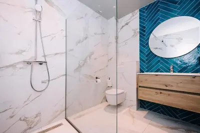 a bathroom with a shower and a toilet and a sink at Hotel Keur - Apartments in Zandvoort