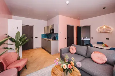 a living room with a couch and a table at Hotel Keur - Apartments in Zandvoort