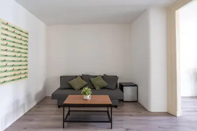 a living room with a couch and a table at Penthouse Amsterdam Dam Square in Amsterdam