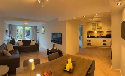 a living room with a couch and a table at B&B Schiphol Amsterdam in Rijsenhout