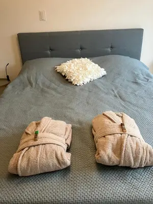 a bed with two towels on top of it at B&B Schiphol Amsterdam in Rijsenhout