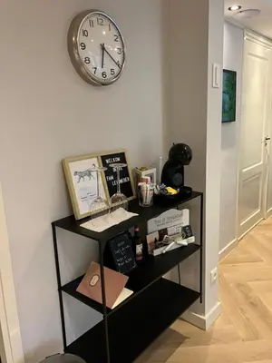 a shelf with a clock on a wall at B&B Schiphol Amsterdam in Rijsenhout