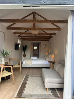 a bedroom with a bed and a couch at Huisje Marie in Zandvoort