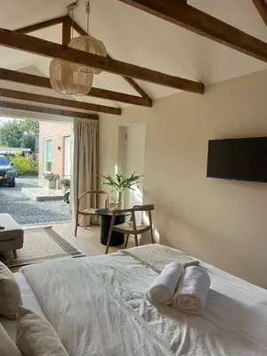 a bedroom with a bed and a tv on the wall at Huisje Marie in Zandvoort